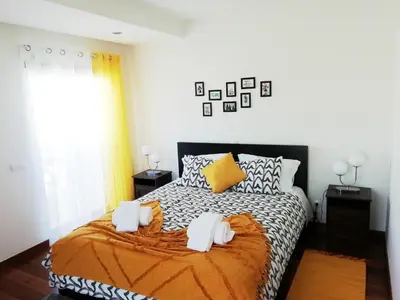 a bedroom with a bed with two towels on it at Sunny Retreat in Luz