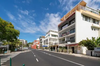 an empty street in a city with buildings at Lido View Calla by An Island Apart in Funchal