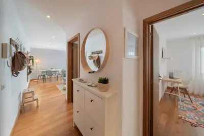 a living room with a mirror and a table at Lido View Calla by An Island Apart in Funchal
