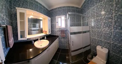 a bathroom with a sink and a mirror at Authentic Rural Retreat With Green Fields & Ocean Views - Orchid House Arco da Calheta in Calheta