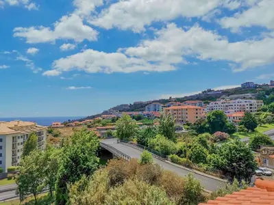 a view of a city with a bridge over a road at Caniço Penthouse by Homie in Santa Cruz