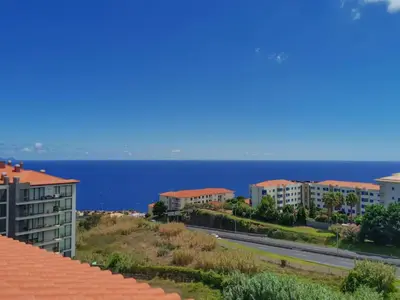 a view of the ocean from the roof of a building at Caniço Penthouse by Homie in Santa Cruz