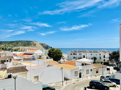 a view of a town with houses and the ocean at Apartamento Maria Fernanda, in the Centre of Luz in Luz