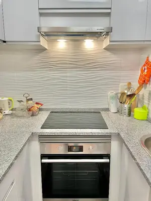 a kitchen with a stainless steel stove top oven at Apartamento Maria Fernanda, in the Centre of Luz in Luz