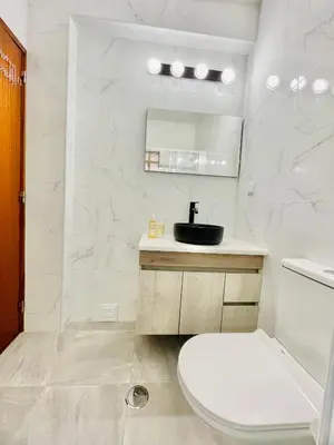 a white bathroom with a toilet and a sink at Apartamento Maria Fernanda, in the Centre of Luz in Luz