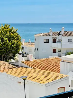 a view of the ocean from the roofs of houses at Apartamento Maria Fernanda, in the Centre of Luz in Luz