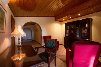 a living room with a table and red chairs at A House With a View in Aljezur