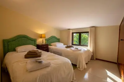 a bedroom with two beds and a window at A House With a View in Aljezur