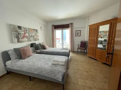 a living room with a bed and a couch at M&M's Cosy apartment - Sea view in Luz