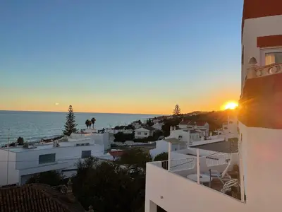 a view of the sunset from a building at M&M's Cosy apartment - Sea view in Luz