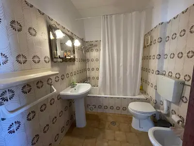 a bathroom with a sink and a toilet and a tub at M&M's Cosy apartment - Sea view in Luz