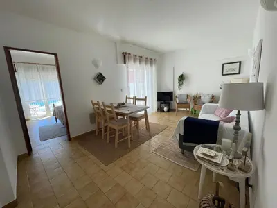 a living room with a couch and a table at M&M's Cosy apartment - Sea view in Luz