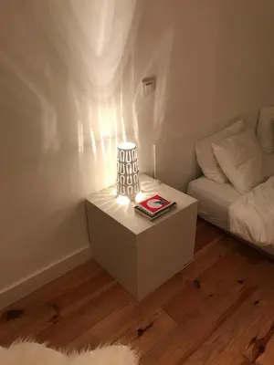 a room with a bed and a table with a lamp at City center boutique apartment in Funchal