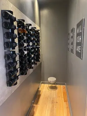 a room with a bunch of wine bottles on a wall at City center boutique apartment in Funchal