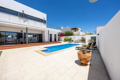 a swimming pool in the backyard of a house at Pontalaia Village in Sagres
