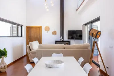 a living room with a couch and a table at Pontalaia Village in Sagres