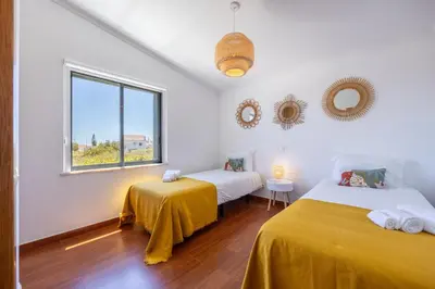 a room with two beds and a window at Pontalaia Village in Sagres