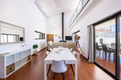 a living room with a white table and a couch at Pontalaia Village in Sagres