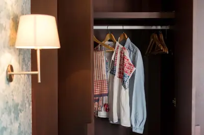 a room with a closet with a lamp and clothes at Apartamentos Santa Maria by Heart of Funchal in Funchal