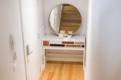 a bathroom with a mirror and a dressing table at Apartamentos Santa Maria by Heart of Funchal in Funchal