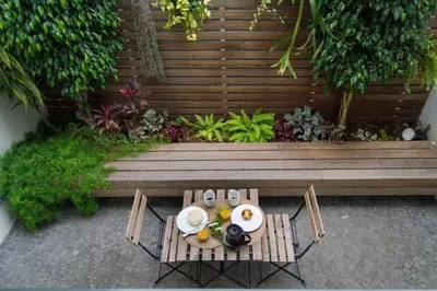 a table with a plate of food on it next to a bench at Apartamentos Santa Maria by Heart of Funchal in Funchal