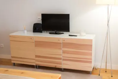 a tv sitting on top of a wooden dresser at Apartamentos Santa Maria by Heart of Funchal in Funchal