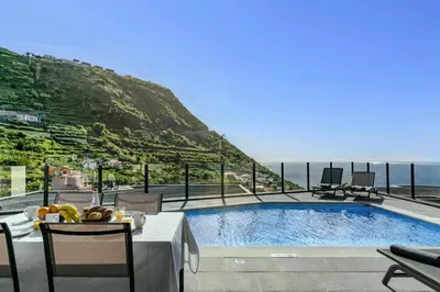 a swimming pool with a view of the ocean at Villa Calheta Charm by Villa Plus in Arco da Calheta