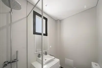 a white bathroom with a sink and a mirror at Villa Old Town by Villa Plus in Funchal