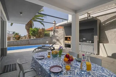 a table with fruit on it on a patio at Villa Old Town by Villa Plus in Funchal