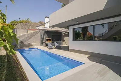 a swimming pool in the backyard of a house at Villa Old Town by Villa Plus in Funchal