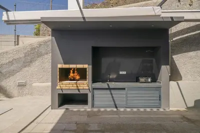 a fireplace in a building with a large screen tv at Villa Old Town by Villa Plus in Funchal