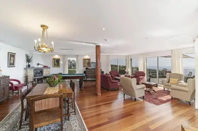 a living room filled with furniture and a table at Villa Theos House by Villa Plus in Fajã da Ovelha