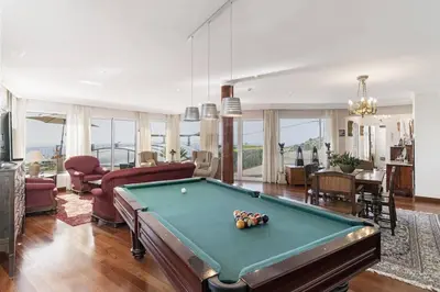 a living room with a pool table at Villa Theos House by Villa Plus in Fajã da Ovelha