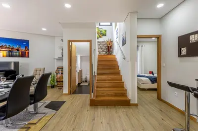 a living room with a staircase leading to a bedroom at Casa da Praia, 2min de la PLAGE, hyper centre in Machico