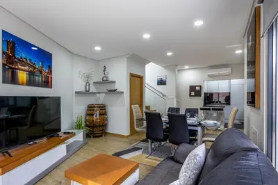 a living room with a couch and a table at Casa da Praia, 2min de la PLAGE, hyper centre in Machico