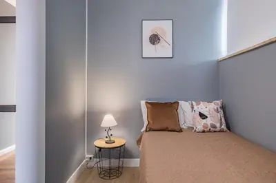 a bedroom with a bed and a side table at Canico Vip Lodging by Homie in Santa Cruz