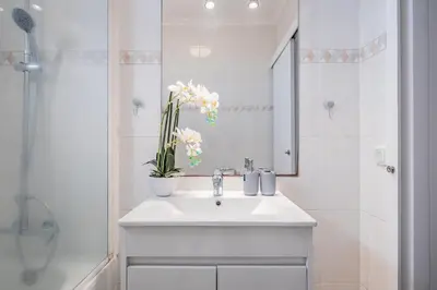 a white bathroom with a sink and a mirror at Canico Vip Lodging by Homie in Santa Cruz