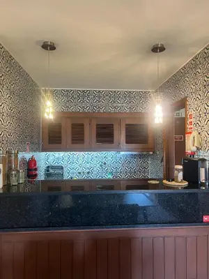 a kitchen with a black counter and blue tiles at Discovery Apartment with patio Discovery 2 in Machico