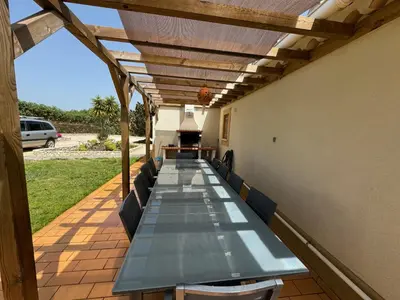 a long long table with benches on a patio at Villa Rubix in Luz