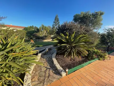 a garden with plants and a brick walkway at Villa Rubix in Luz