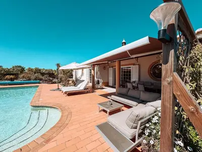 a house with a swimming pool and a patio at Villa Rubix in Luz
