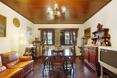 a living room with a table and a couch at Suites Pinto Coelho in Caniço