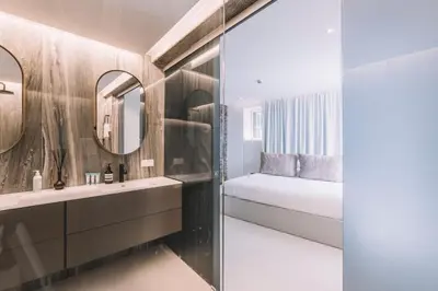 a bathroom with a bed and a mirror at QUINTA TORRINHA GARDEN Apartment in Funchal