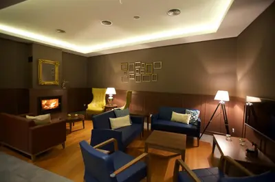 a living room with blue chairs and a fireplace at Charming Blue in Vila do Porto