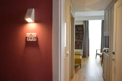 a hallway with a red wall with a light on it at Charming Blue in Vila do Porto