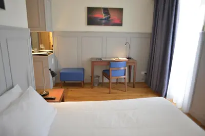 a bedroom with a bed and a desk and a table at Charming Blue in Vila do Porto