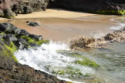a beach with waves crashing on the rocks at Charming Blue in Vila do Porto