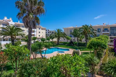 an aerial view of a resort with a pool and palm trees at Casa Palmeira in Lagos
