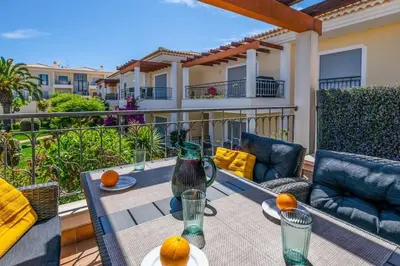 a patio with a table and chairs on a balcony at Casa Palmeira in Lagos
