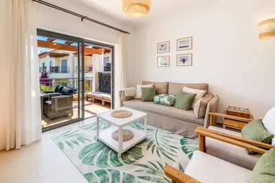 a living room with a couch and a table at Casa Palmeira in Lagos